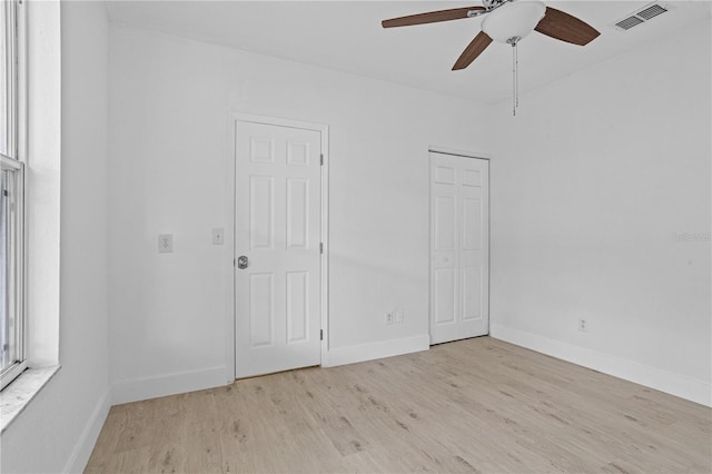 unfurnished room with ceiling fan and light wood-type flooring