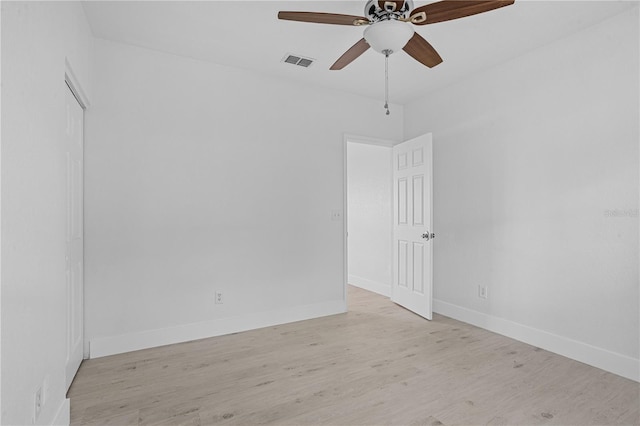 empty room with light hardwood / wood-style floors and ceiling fan