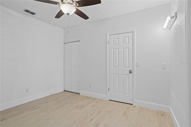 spare room featuring ceiling fan and light wood-type flooring