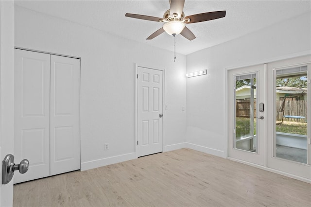 empty room with light hardwood / wood-style floors and ceiling fan