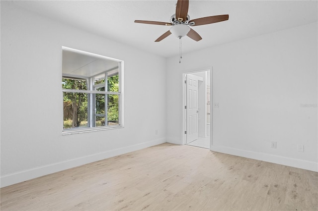 spare room featuring light wood-type flooring and ceiling fan