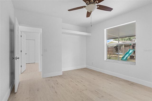 empty room featuring light wood-type flooring and ceiling fan