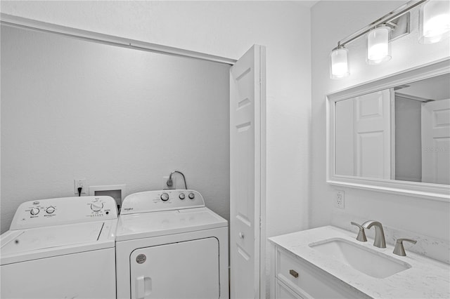 washroom with sink and separate washer and dryer