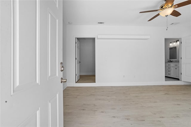 empty room with light hardwood / wood-style flooring and ceiling fan