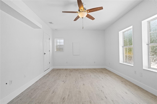 unfurnished room featuring light hardwood / wood-style flooring, ceiling fan, and plenty of natural light