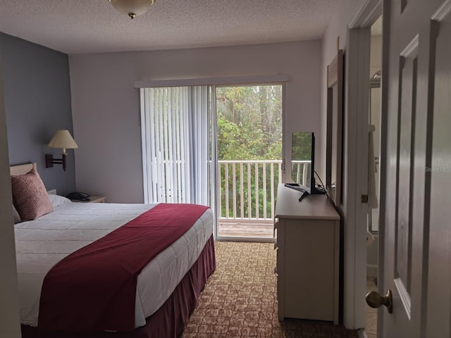 bedroom featuring a textured ceiling and access to outside