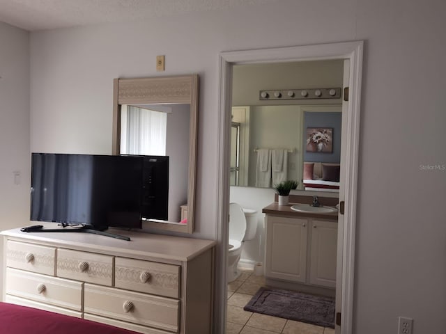 bedroom featuring sink and light tile patterned floors