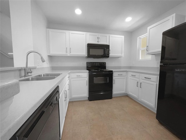 kitchen featuring sink, white cabinets, and black appliances