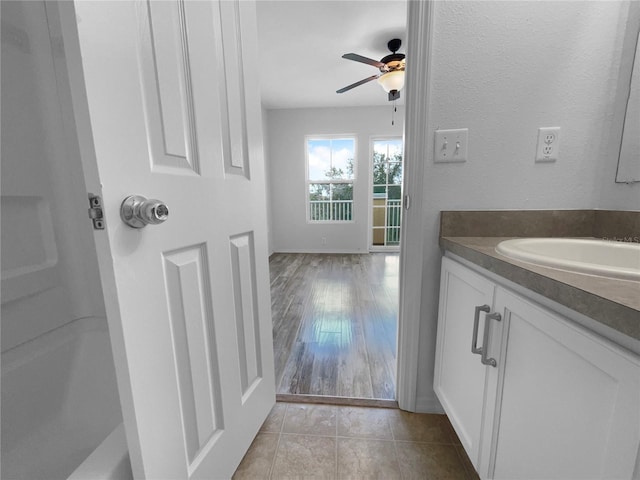 bathroom featuring tile patterned flooring, vanity, and ceiling fan