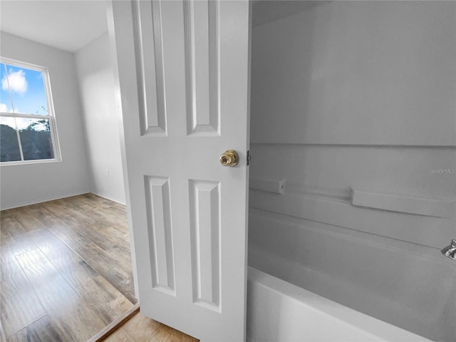 bathroom with hardwood / wood-style floors