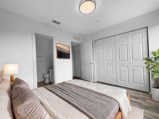 bedroom featuring hardwood / wood-style flooring, connected bathroom, and a closet