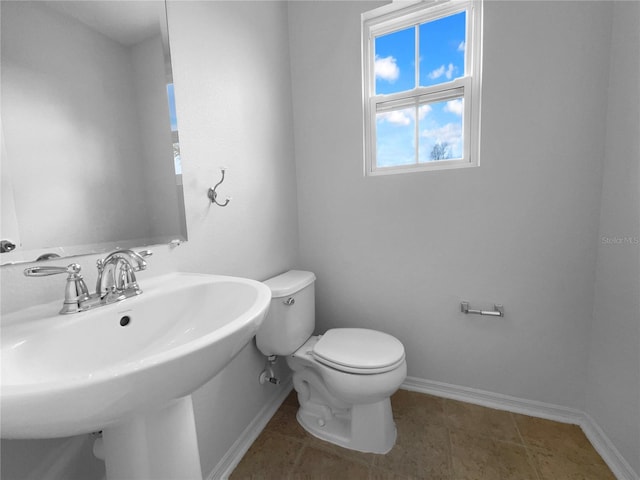 bathroom featuring sink, tile patterned floors, and toilet