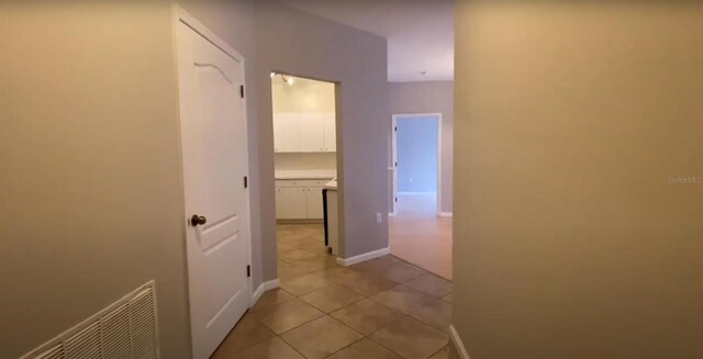 hallway featuring light tile patterned flooring