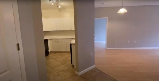 corridor featuring light tile patterned flooring