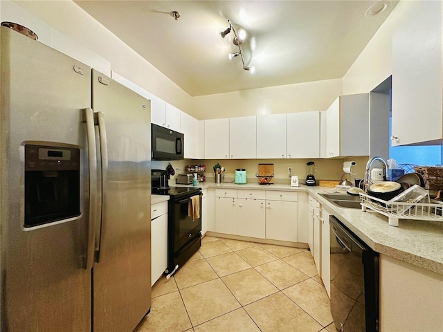 kitchen with light tile patterned floors, black appliances, and white cabinets