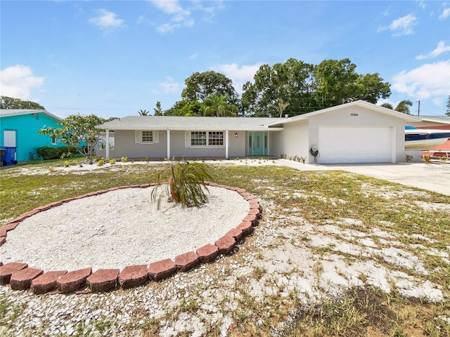 single story home featuring a garage and a front lawn