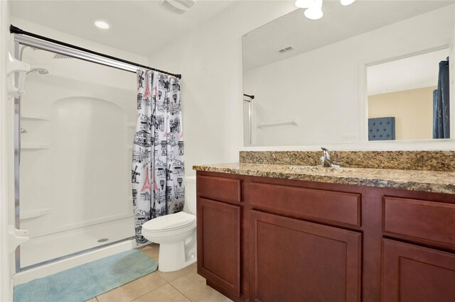 bathroom featuring vanity, toilet, tile patterned floors, and a shower with shower curtain