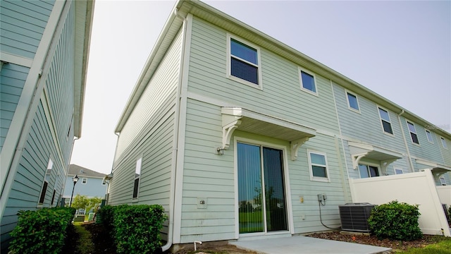 rear view of house with cooling unit