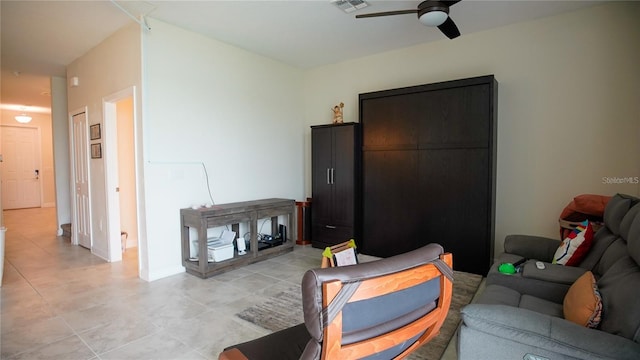 tiled living room featuring ceiling fan