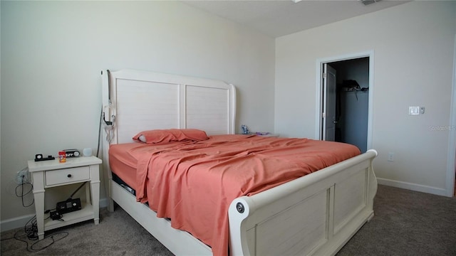 bedroom featuring carpet floors and a walk in closet