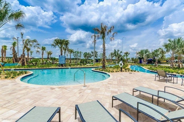 view of swimming pool with a patio area