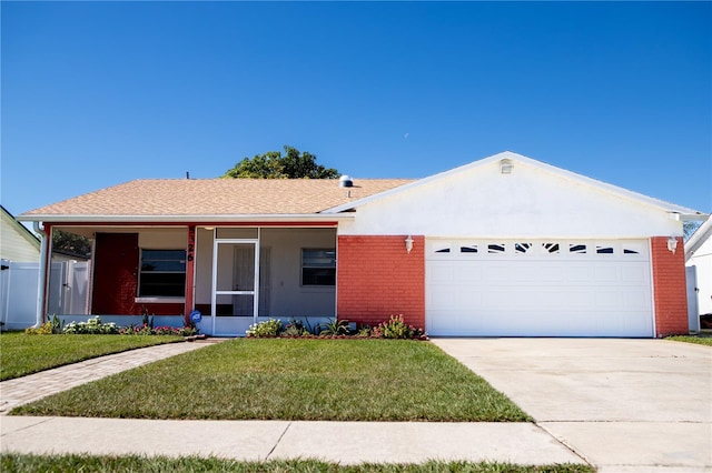 ranch-style house featuring a front yard and a garage