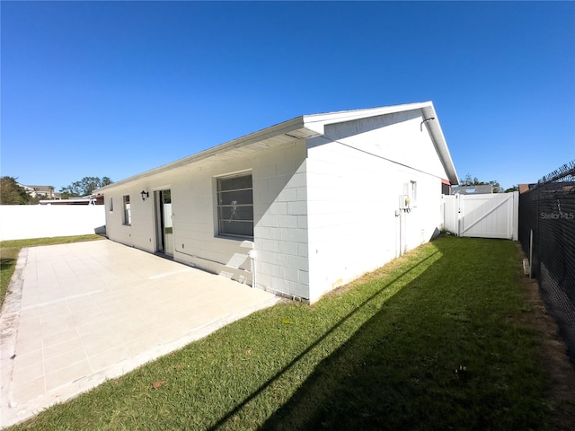 back of house featuring a patio area and a yard