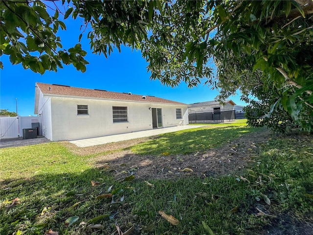 rear view of house featuring central AC, a patio area, and a yard