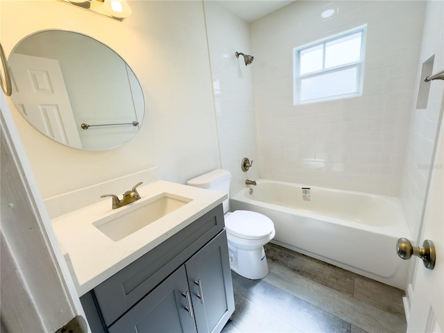 full bathroom featuring wood-type flooring, vanity, toilet, and tiled shower / bath