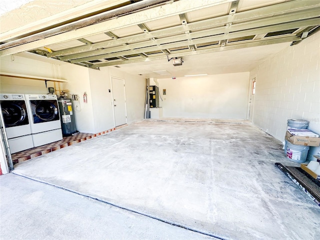 garage with washing machine and dryer, electric water heater, and a garage door opener