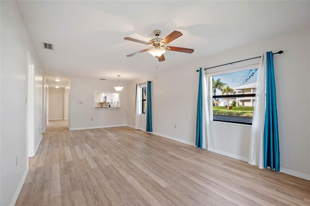 spare room featuring light hardwood / wood-style floors and ceiling fan