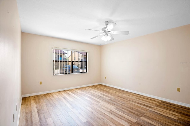 empty room with ceiling fan and light hardwood / wood-style floors