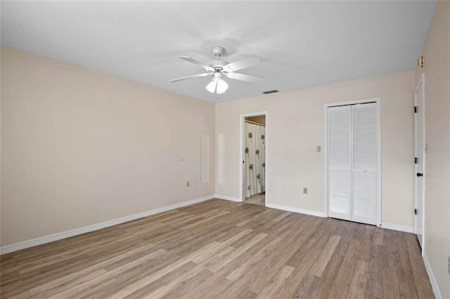 unfurnished bedroom featuring light hardwood / wood-style flooring, a closet, and ceiling fan