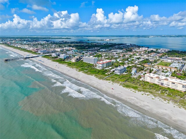 drone / aerial view with a water view and a view of the beach