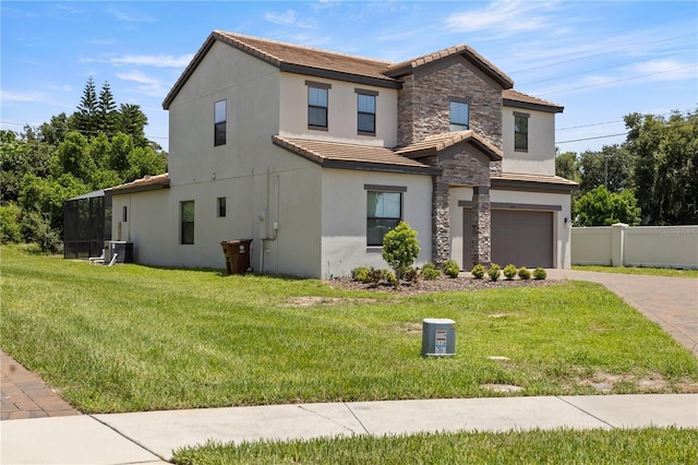 view of front of house featuring a front lawn, a garage, and cooling unit