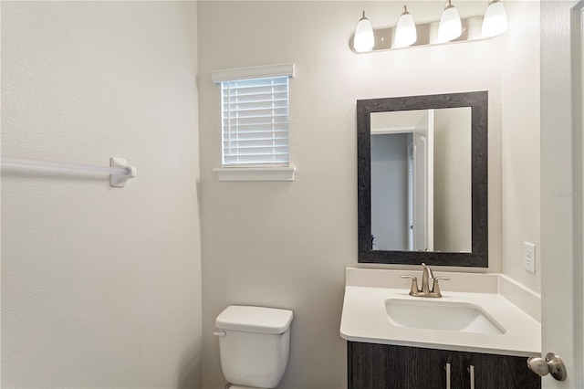 bathroom with toilet and vanity