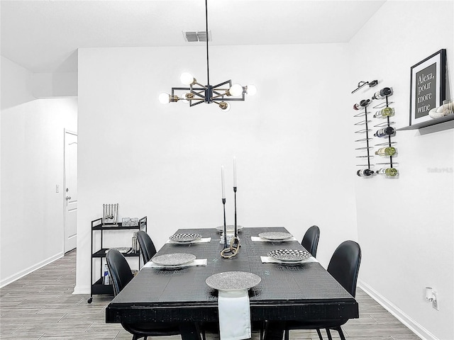 dining area with an inviting chandelier