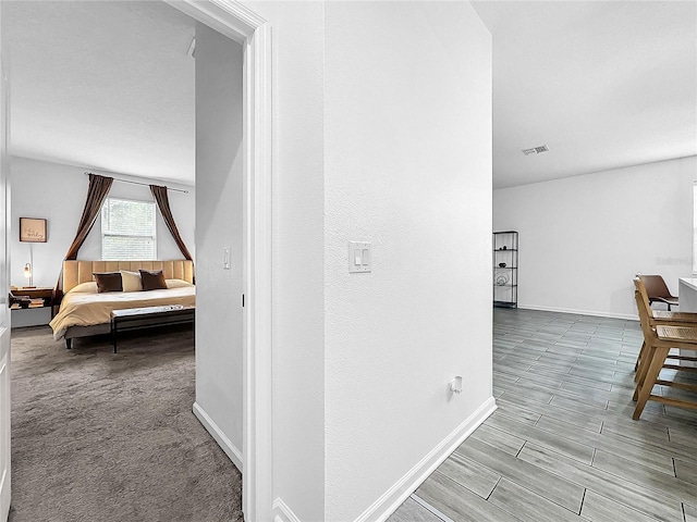 hallway with light colored carpet