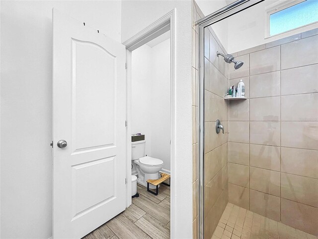 bathroom featuring toilet and walk in shower