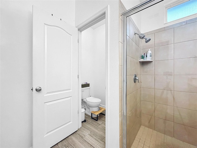 bathroom featuring walk in shower and toilet