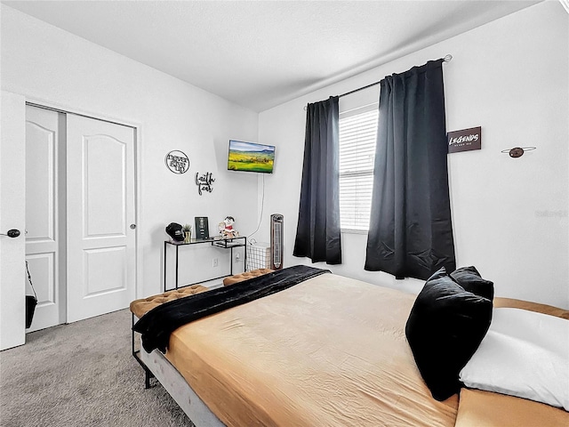 bedroom featuring light carpet and a closet