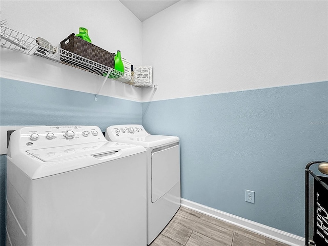 clothes washing area with washing machine and clothes dryer