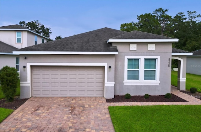 view of front facade featuring a garage and a front lawn