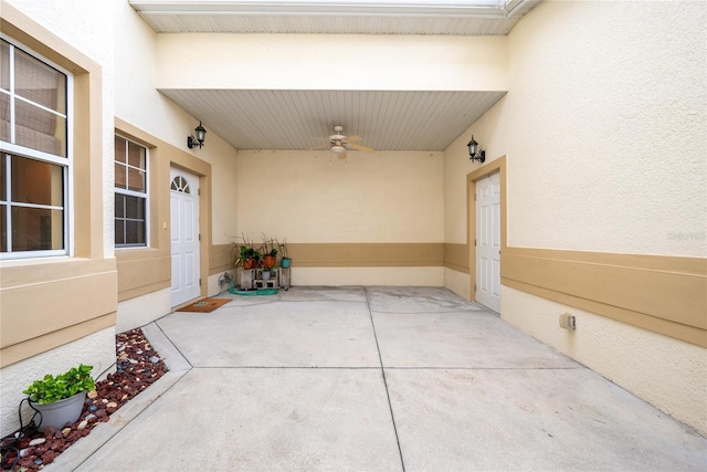 view of exterior entry with ceiling fan