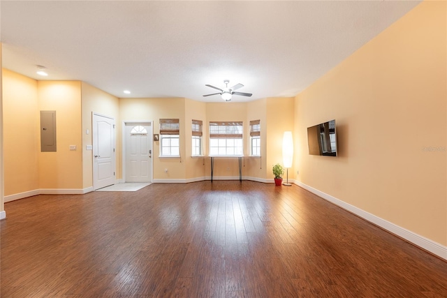 unfurnished living room featuring ceiling fan, wood-type flooring, and electric panel