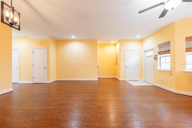 unfurnished living room with ceiling fan and dark hardwood / wood-style flooring