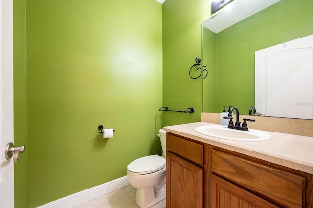 bathroom with tile patterned floors, vanity, and toilet