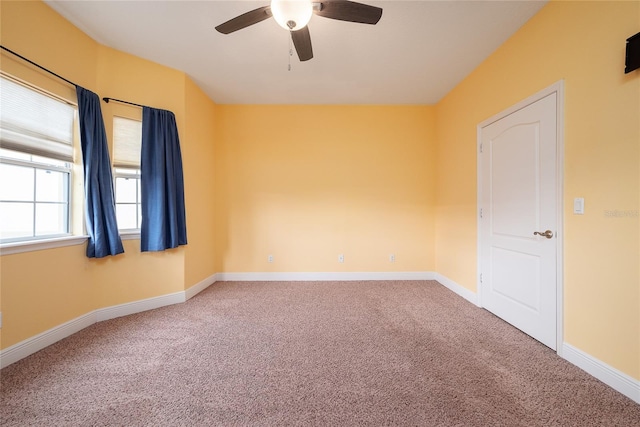 empty room featuring carpet flooring and ceiling fan