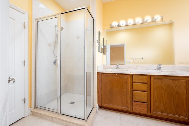 bathroom with tile patterned floors, a shower with door, and vanity