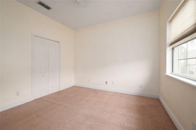 unfurnished bedroom featuring carpet floors and a closet